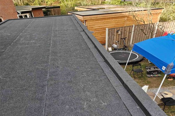a modern, durable flat roof likely made of EPDM rubber membrane or a felt system