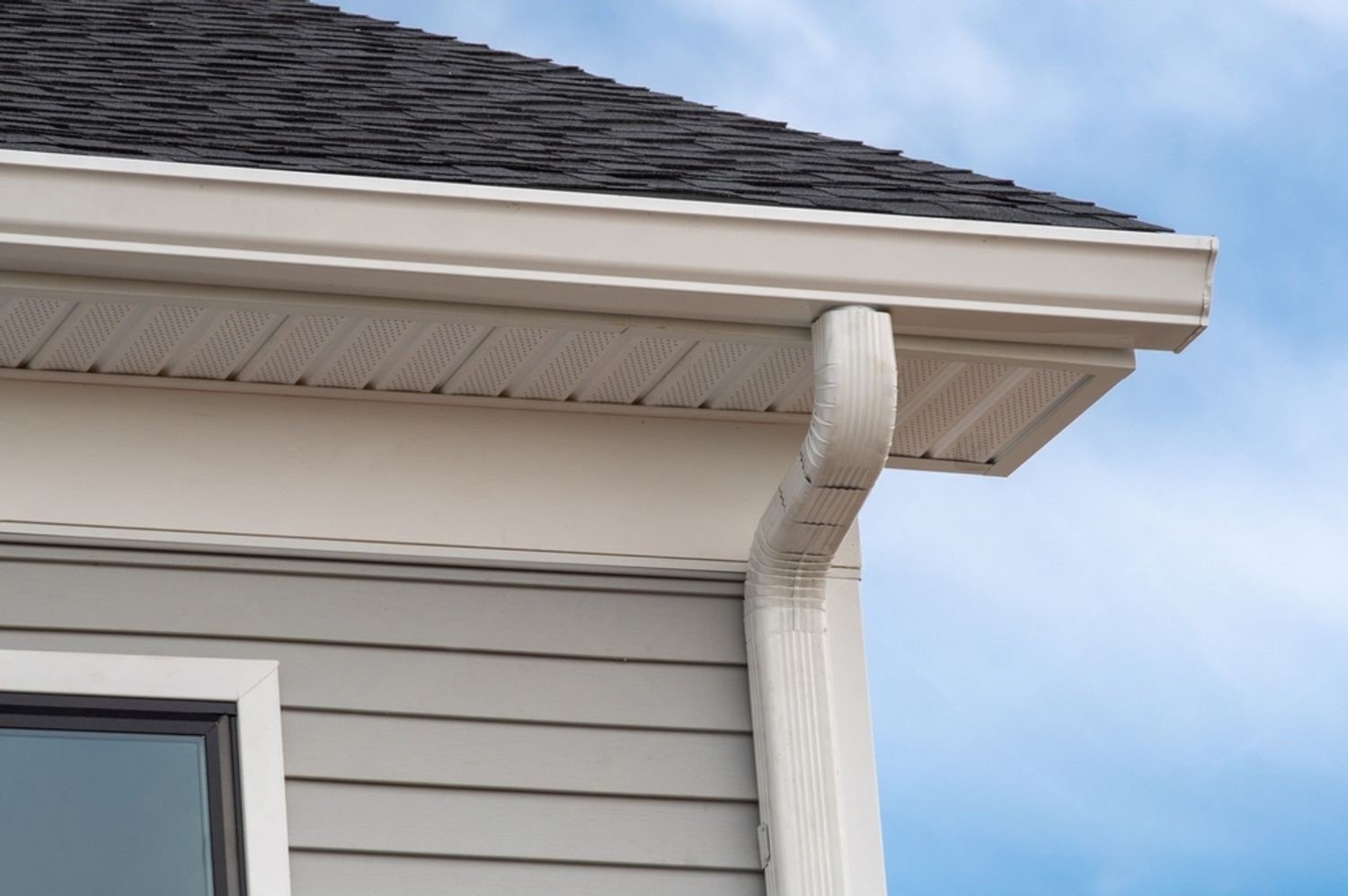 a seamless gutter system on the side of a building